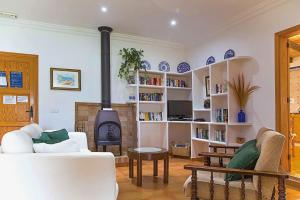 a living room with a fireplace and a stove at Villa Vilar by Sealand Villas in El Port
