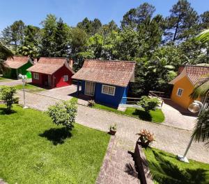 a group of small houses in a yard at Pousada Vale Dos Figos in Urussanga