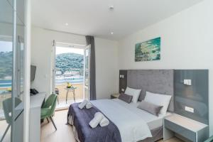 a bedroom with a bed and a view of the ocean at Art Hotel Dubrovnik in Dubrovnik