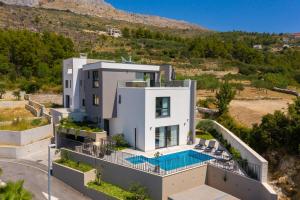 an aerial view of a house with a swimming pool at Villa 9 in Podstrana