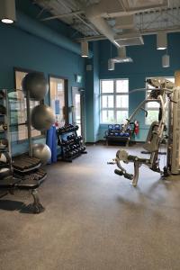 a gym with several tread machines in a room at Coast Canmore Hotel & Conference Centre in Canmore