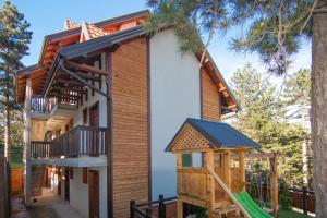 a house with a playground in front of it at Simic Apartmani Tara in Kaludjerske Bare
