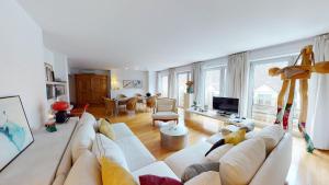 a living room with a white couch and a tv at Amazing View_Loft Apartment in the heart of Vienna in Vienna