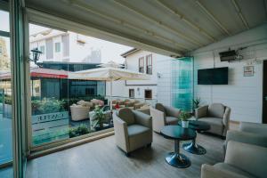 a lobby with chairs and tables and a large window at 216 Castle Hotel in Gebze