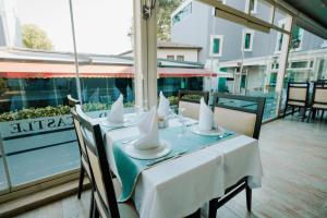 a table with white napkins and bowls on top at 216 Castle Hotel in Gebze