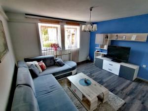 a living room with a couch and a coffee table at Apartment ELLA in Tuzla