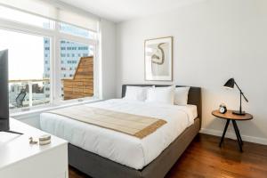 a bedroom with a large bed and a window at Kislak 601 1BR Penthouse with Stunning Rooftop Terrace in Newark