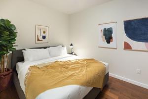a bedroom with a bed with a gold blanket on it at Kislak 304 Chic Studio in the Heart of Downtown in Newark