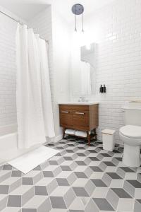 a bathroom with a sink and a toilet and a tub at Kislak 305 Luxurious 1BR in Heart of Downtown in Newark