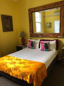 a bedroom with a large bed and a large window at Vine Valley Inn in Cessnock