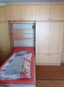 a small bedroom with a bed and cabinets at Appartemant Steineberg in Immenstadt im Allgäu