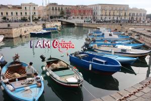 a group of boats are docked in a harbor at I AM Ortigia - Alfeo in Syracuse