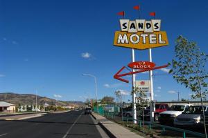 a sign that says "no parking" on the side of a road at Sands Motel in Grants
