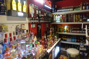 a bar filled with lots of bottles of alcohol at The Kings Cross Hotel in Blackpool