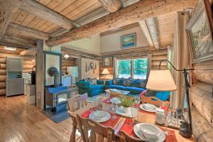 a dining room and living room with a table and chairs at Expansive Moyie Riverfront Cabin - Pets Welcome! in Bonners Ferry