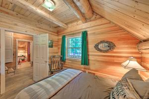 a bedroom with wooden walls and a bed in a room at Expansive Moyie Riverfront Cabin - Pets Welcome! in Bonners Ferry