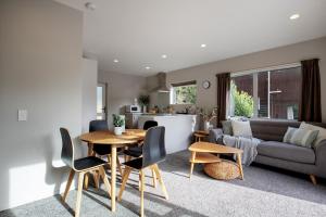 a kitchen and living room with a table and chairs at Punakaiki Beachfront Motels in Punakaiki