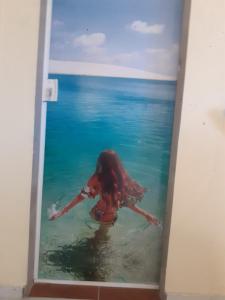 a woman in the water in the ocean at Pousada Beira Rio in Santo Amaro