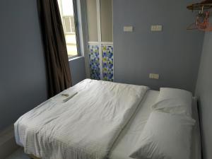 Postel nebo postele na pokoji v ubytování Qeyjan Hotel