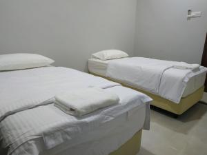 Postel nebo postele na pokoji v ubytování Qeyjan Hotel