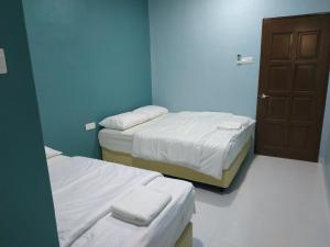 Postel nebo postele na pokoji v ubytování Qeyjan Hotel