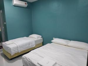 Postel nebo postele na pokoji v ubytování Qeyjan Hotel