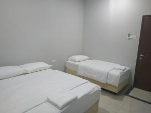 Postel nebo postele na pokoji v ubytování Qeyjan Hotel