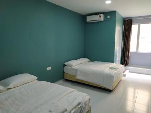 Postel nebo postele na pokoji v ubytování Qeyjan Hotel