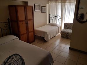 Ένα ή περισσότερα κρεβάτια σε δωμάτιο στο Hotel Tiumara Cartago