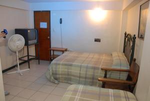 Ένα ή περισσότερα κρεβάτια σε δωμάτιο στο Hotel Tiumara Cartago