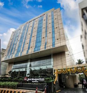 a tall building with glass windows in front of it at Best Western Plus Tejvivaan in Visakhapatnam