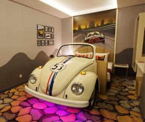 a room with a volkswagen car on the floor at Maison Boutique Theme Hotel Kuala Lumpur by Swing & Pillows in Kuala Lumpur