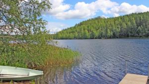a boat sitting on the shore of a lake at Old School in Suolahti