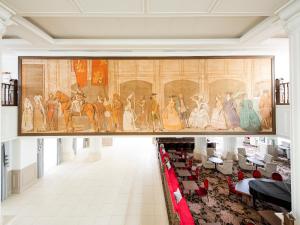 a large painting on the wall of a room in a museum at Takarazuka Hotel in Takarazuka