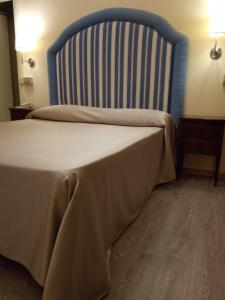 A bed or beds in a room at Hotel Stipino