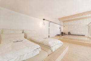 a white room with two beds and a window at NaturparkResort Alte Schule in Hieflau +62 photos