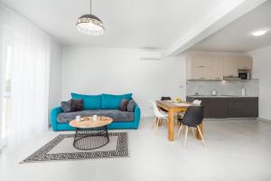 a living room with a blue couch and a table at Villa Ancora in Rovinj