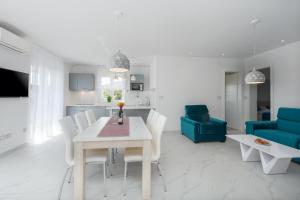 a kitchen and living room with a table and chairs at Villa Ancora in Rovinj