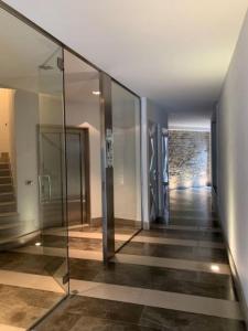 a hallway with glass walls and a staircase in a building at Il Borgo in Trieste