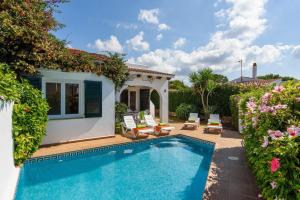 a villa with a swimming pool and a house at Duna Villa, Cala Blanca in Cala Blanca