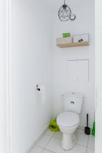 a bathroom with a white toilet in a room at Apartment Epinette 2 bedroomed near Disneyland Paris in Magny-le-Hongre