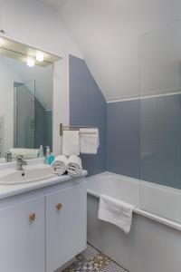 ein Badezimmer mit Waschbecken und Spiegel in der Unterkunft Apartment Epinette 2 bedroomed near Disneyland Paris in Magny-le-Hongre + 6 Fotos