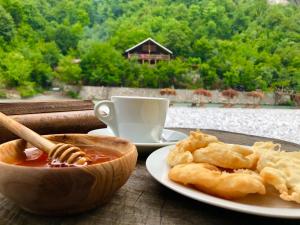 a table with a plate of food and a cup of coffee at Eagles Land in Shkodër
