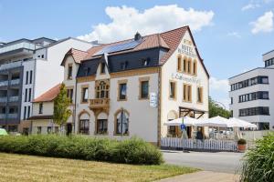 a white building with a red roof at Lothringer Hof in Saarlouis