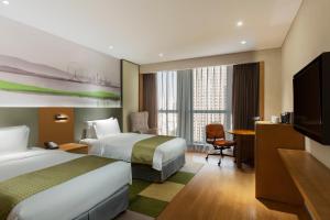 เตียงในห้องที่ Holiday Inn & Suites Tianjin Downtown, an IHG Hotel