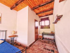 a room with a bed and a wooden ceiling at Suite in vigneto in Passopisciaro