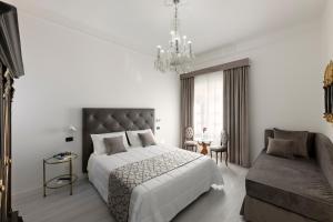 a bedroom with a large bed and a chandelier at Hotel Berna in Florence