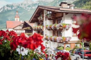 a building with flower boxes on the side of it at Hotel Angelika in Neustift im Stubaital