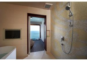 a bathroom with a shower with a view of the ocean at Berjaya Langkawi Resort in Pantai Kok