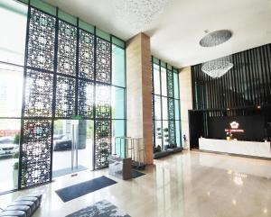 a lobby with large glass windows and a large lobby at Swiss-Garden Hotel Melaka in Melaka